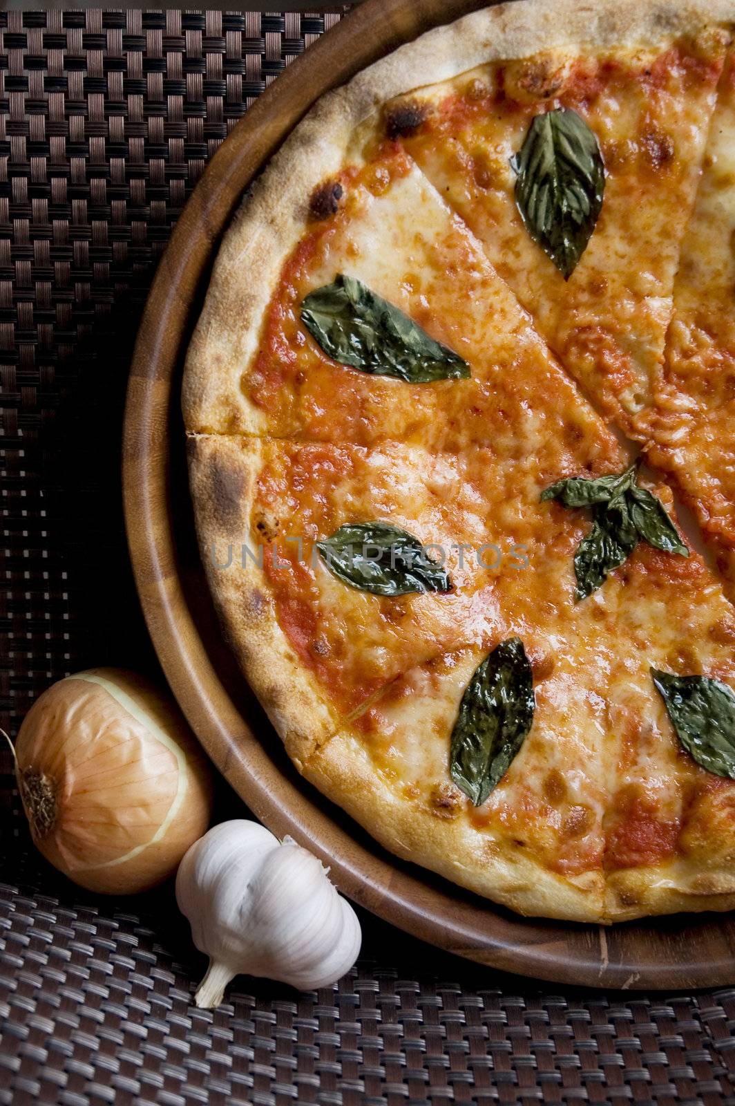 tasty sliced fresh pizza Margherita on wooden pan