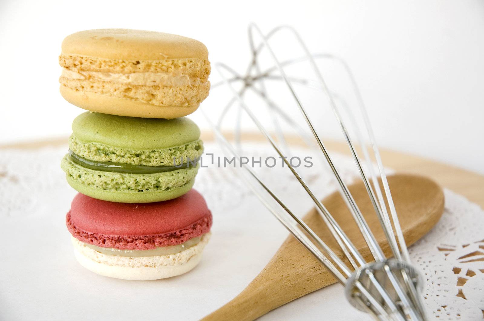 stack of colorful macarons with kitchenware