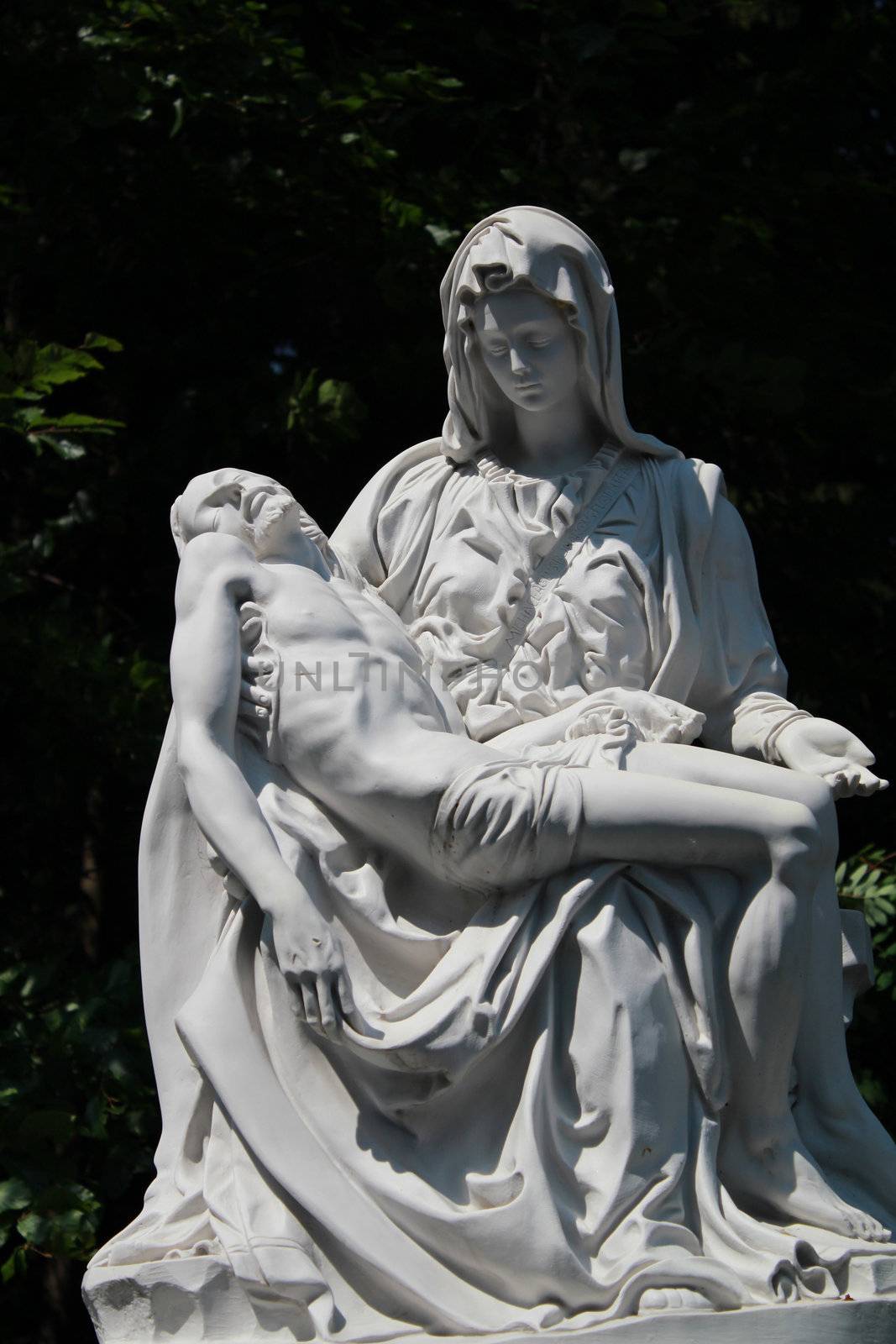 beautiful statue of Holy Mary holding the Corpus Christi on her lap