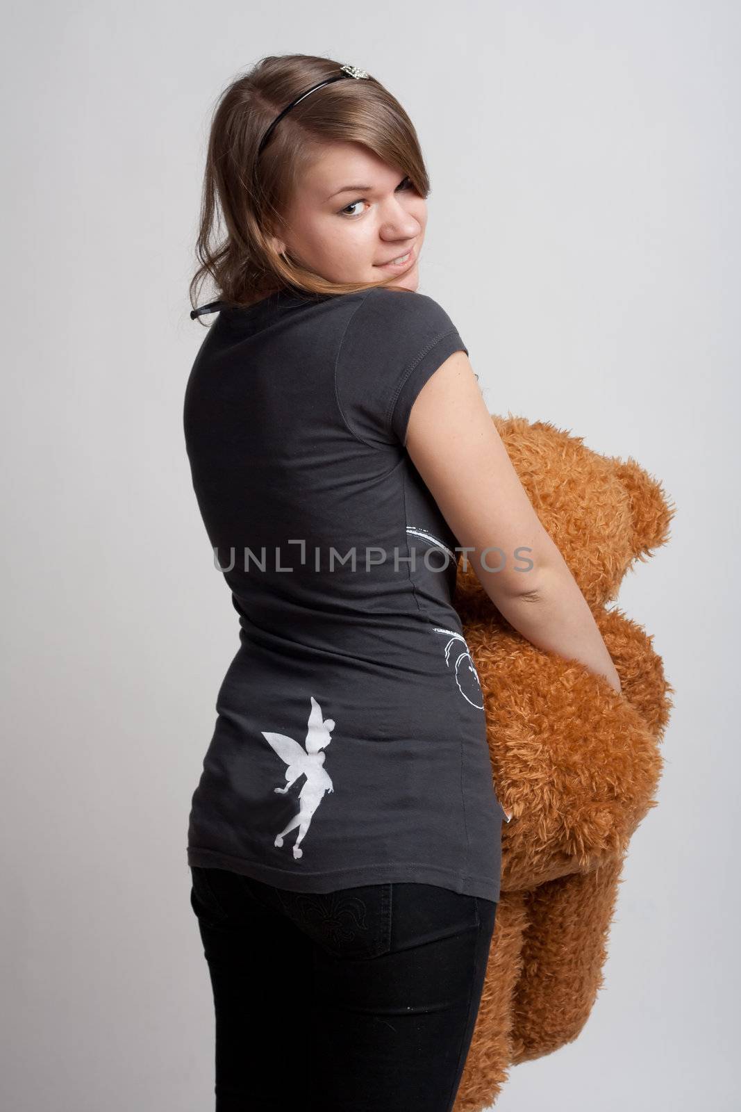 girl on a white background with a toy in his hand