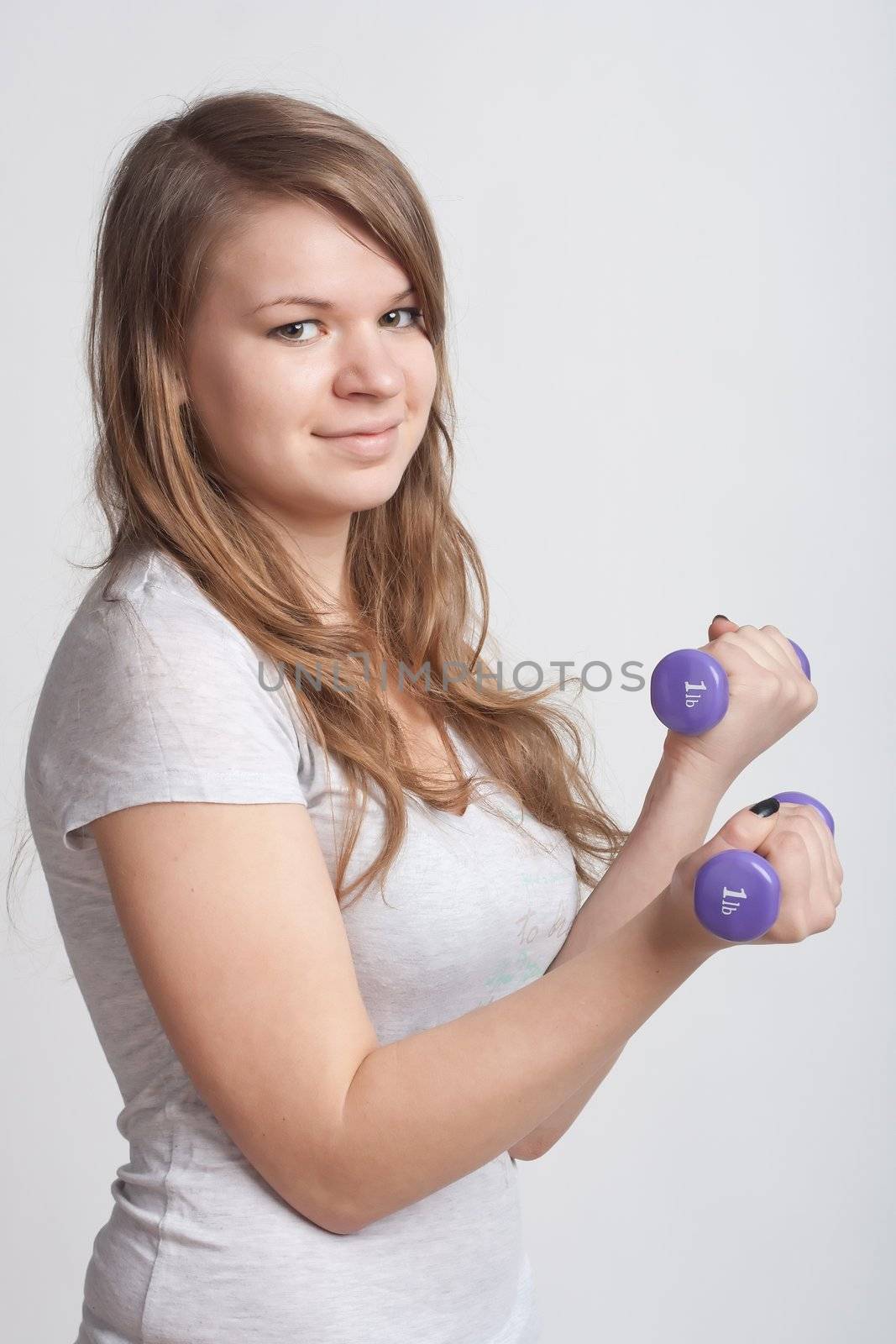 girl with dumbbells in hand by victosha