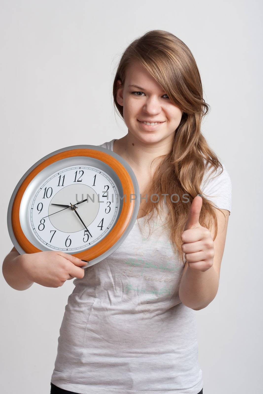 beautiful girl with a big clock in his hands