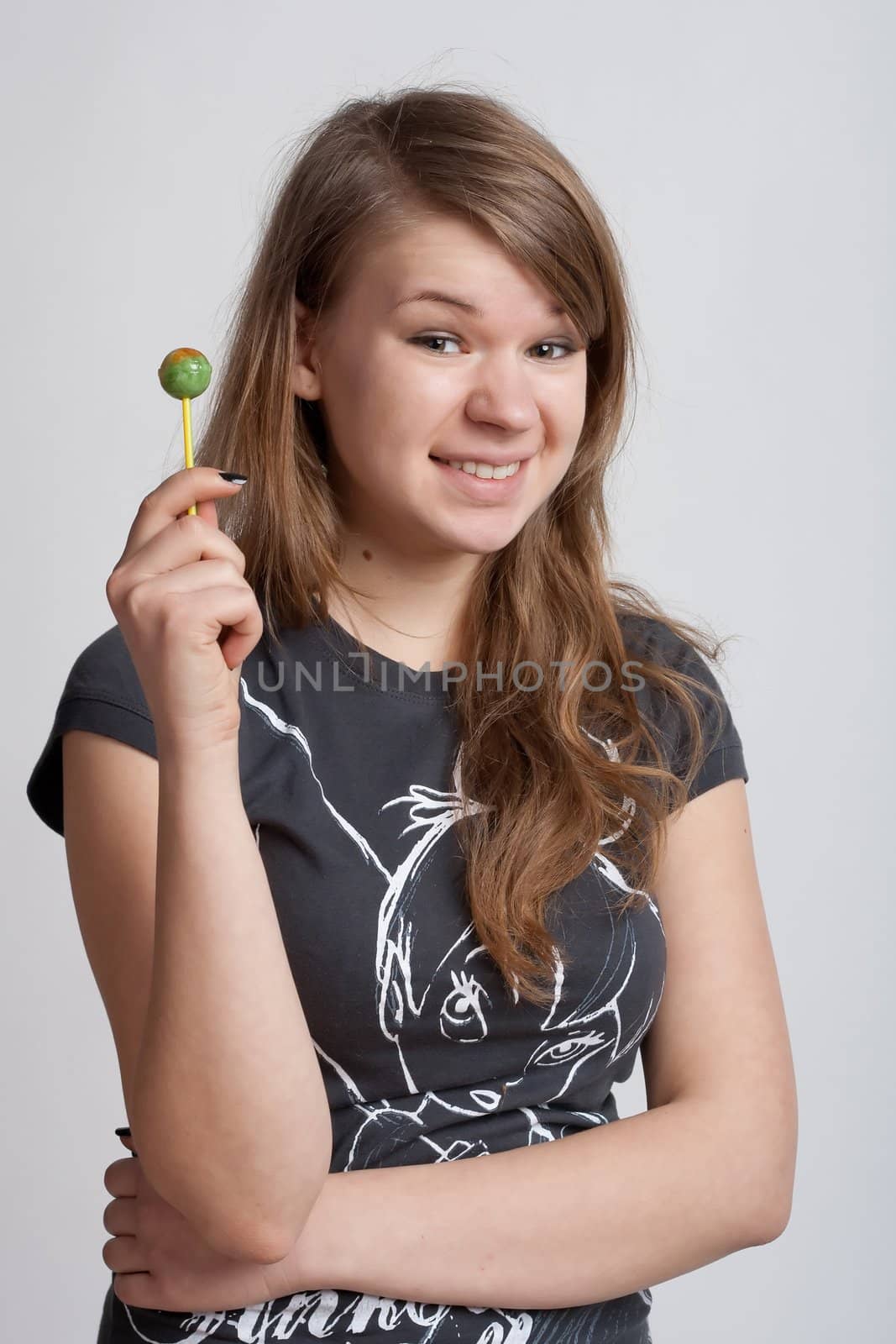 girl on a white background with candy on a stick in his hand