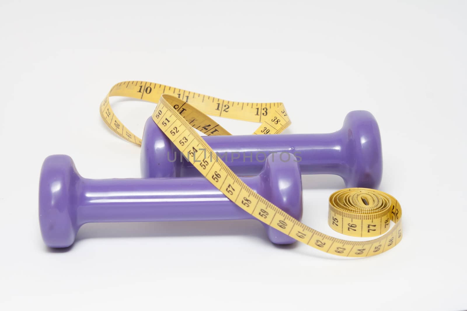 purple dumbbells and a yellow measuring tape on white background