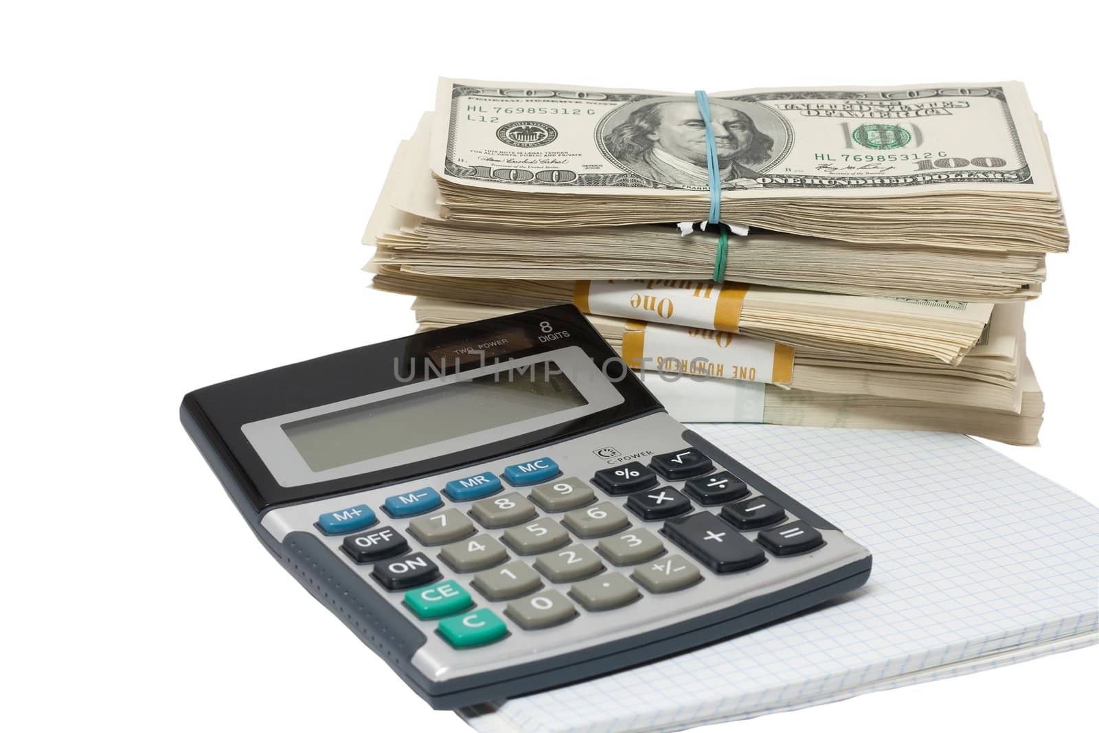 a bundle of money and a calculator on a white background