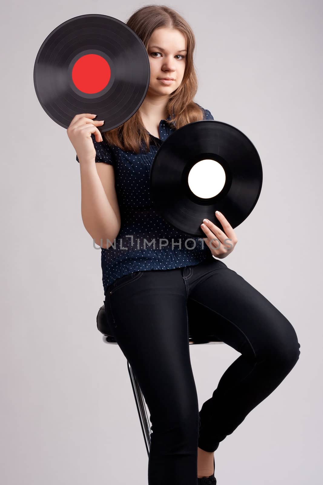 girl with two musical records in the hands of