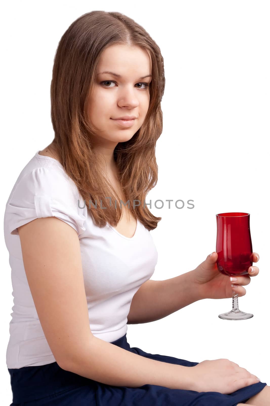 A girl in a bright red T-shirt and a glass sitting on a white background