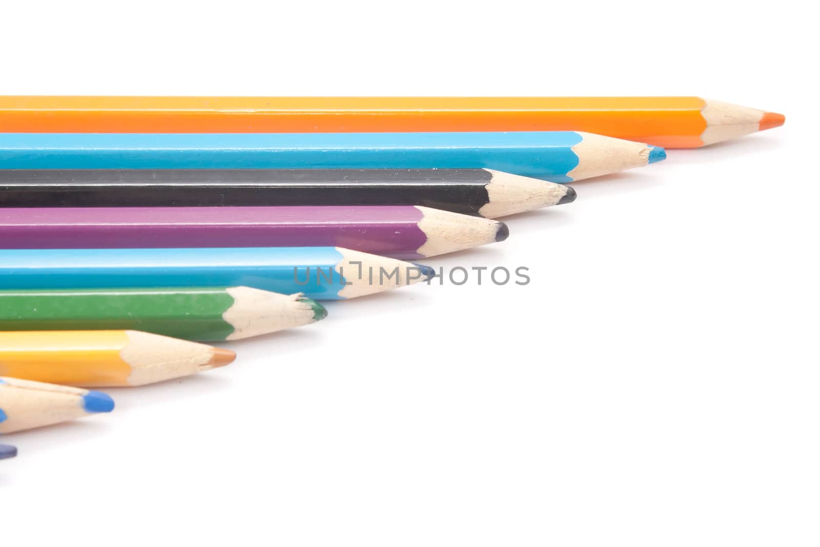 crayons are cascaded on a white background