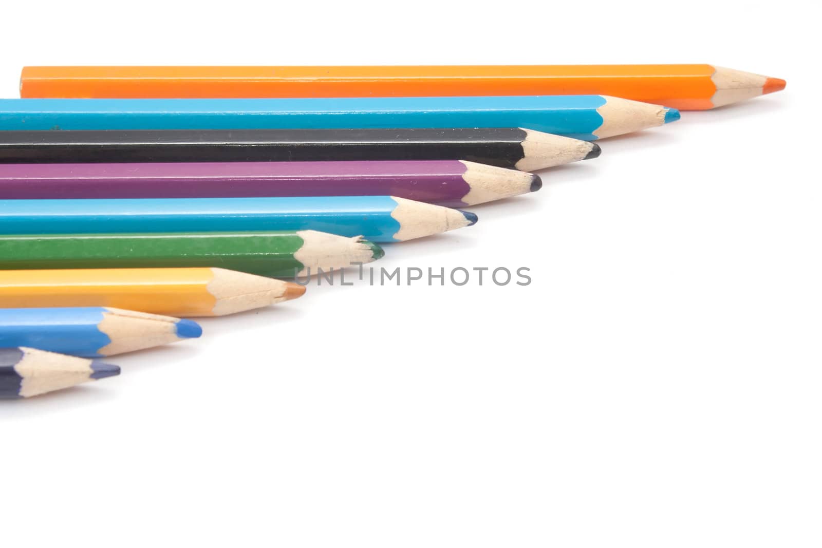 crayons are cascaded on a white background