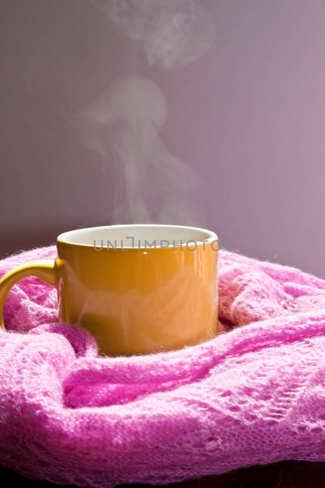 cup with steam in the scarf