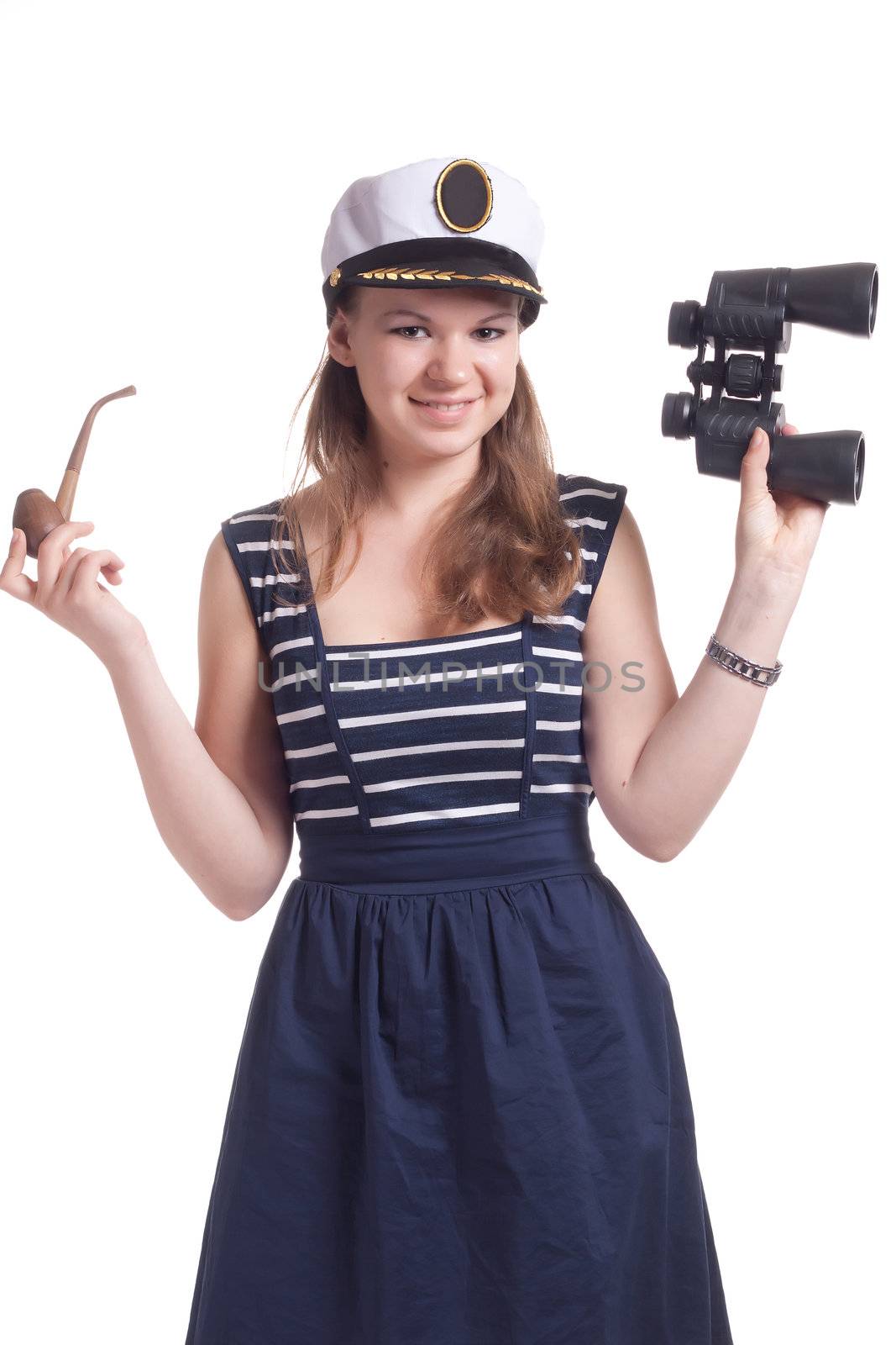 A girl in a sailor cap holding a pair of binoculars and a pipe for smoking on a white background