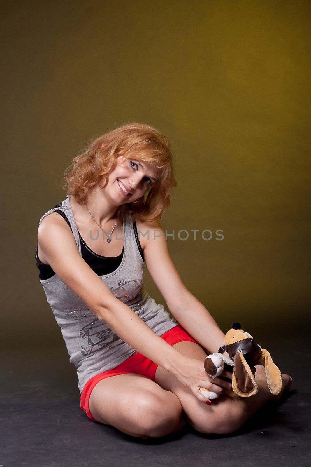 A beautiful red-haired girl with a soft toy in the hands  by victosha