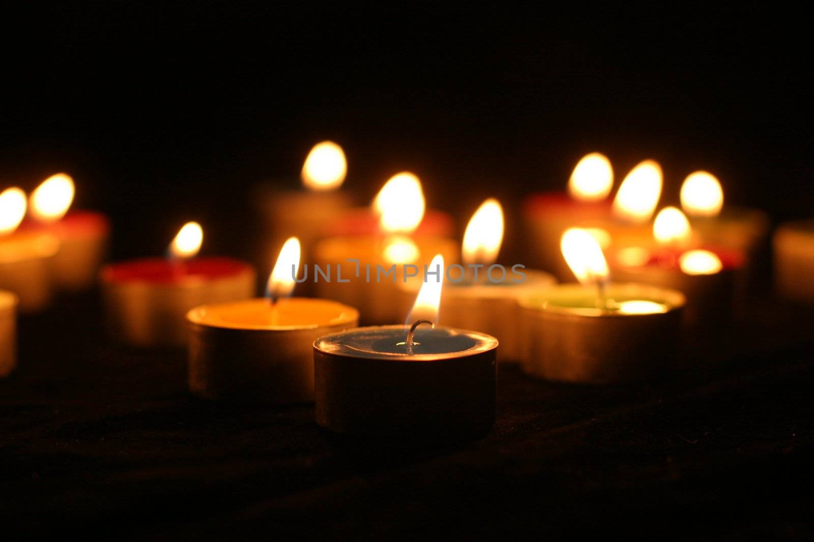 Closeup of burning candles outside in winter time