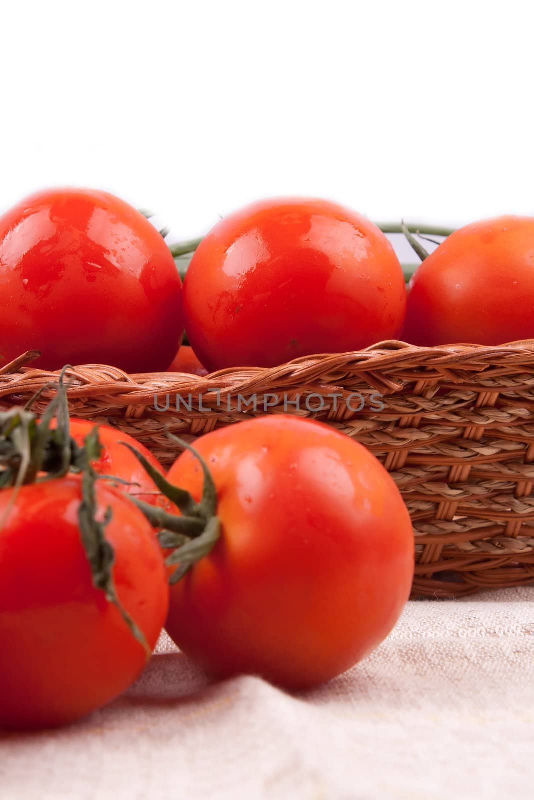 Red tomatoes in a basket by victosha