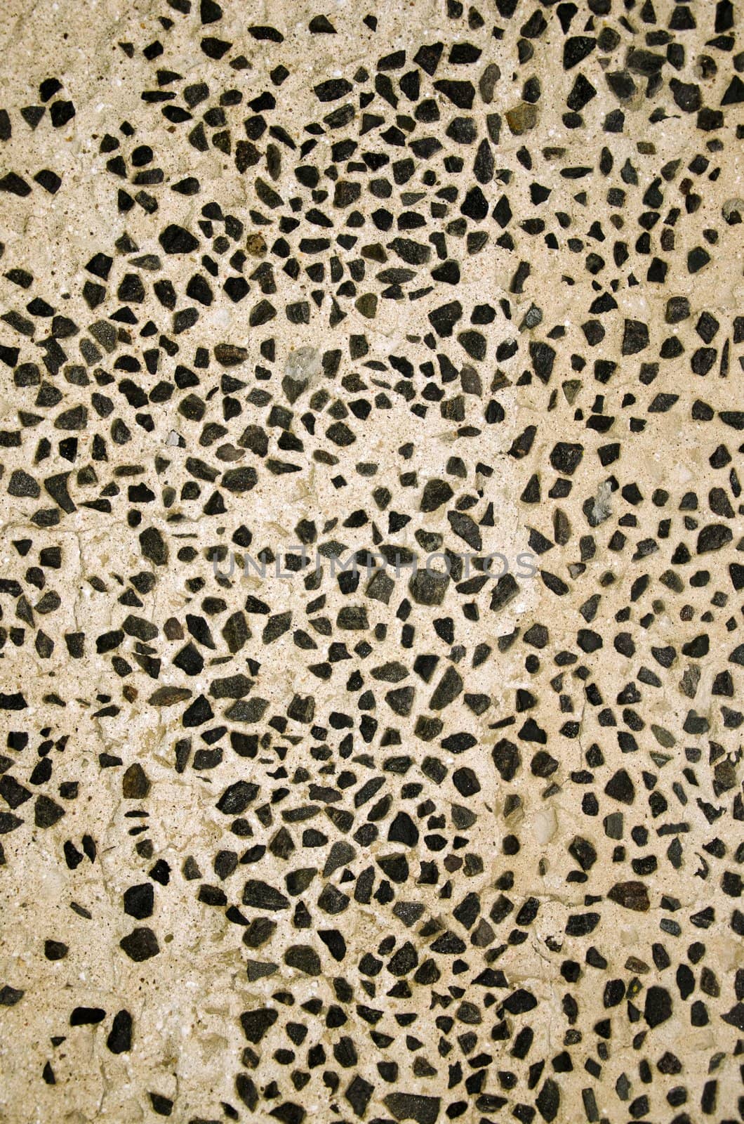 Wall decorated with small flint stones. Architecture background details.