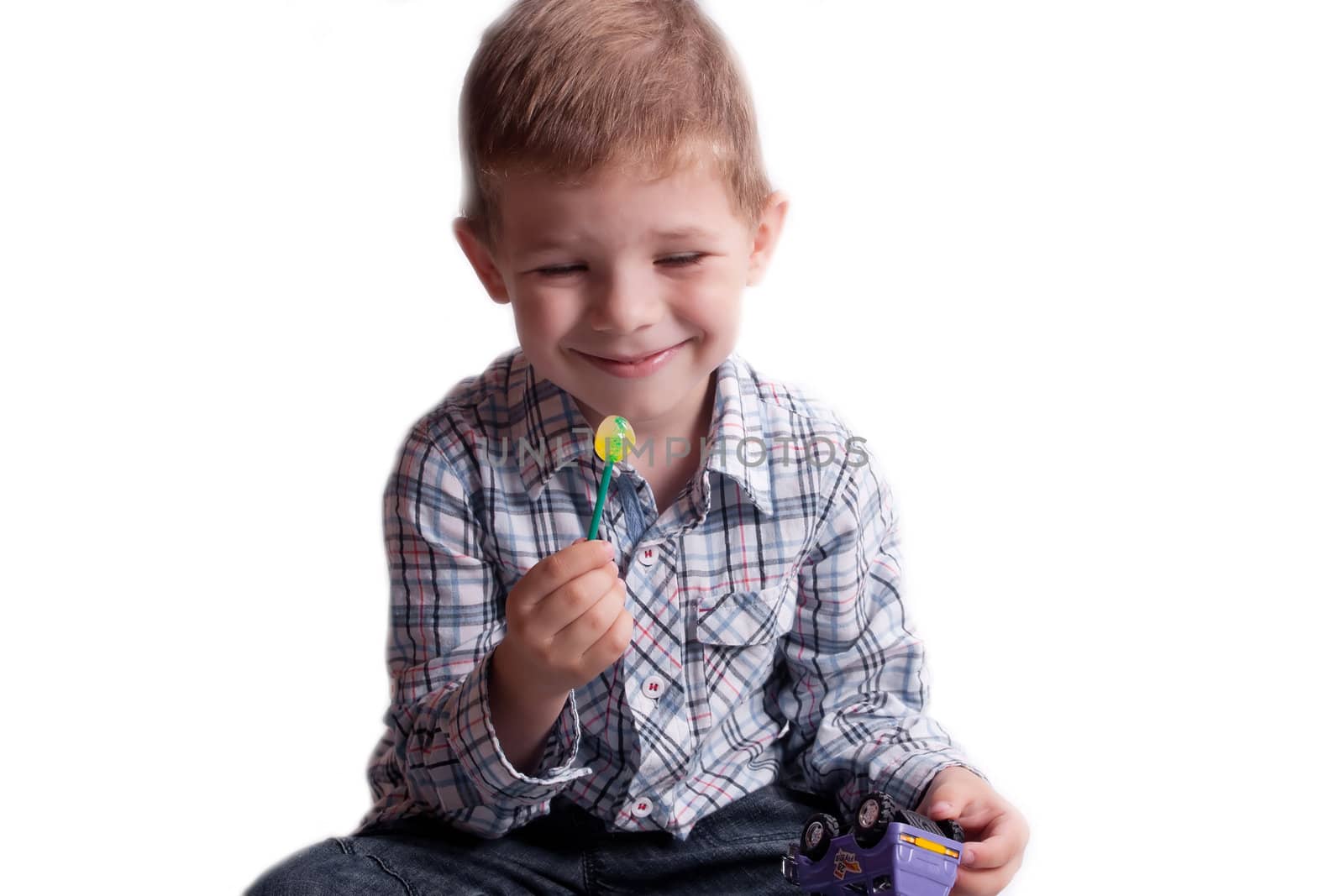 A little boy with candy on a white background