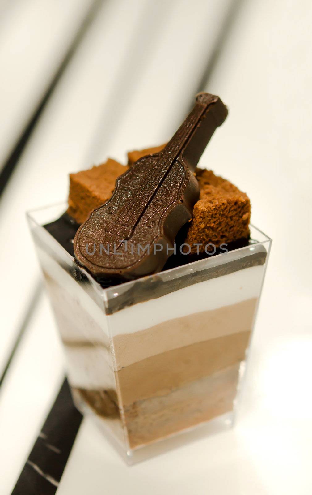 cheese cake , decorated with brownies and chocolate , served in a bowl with a small 