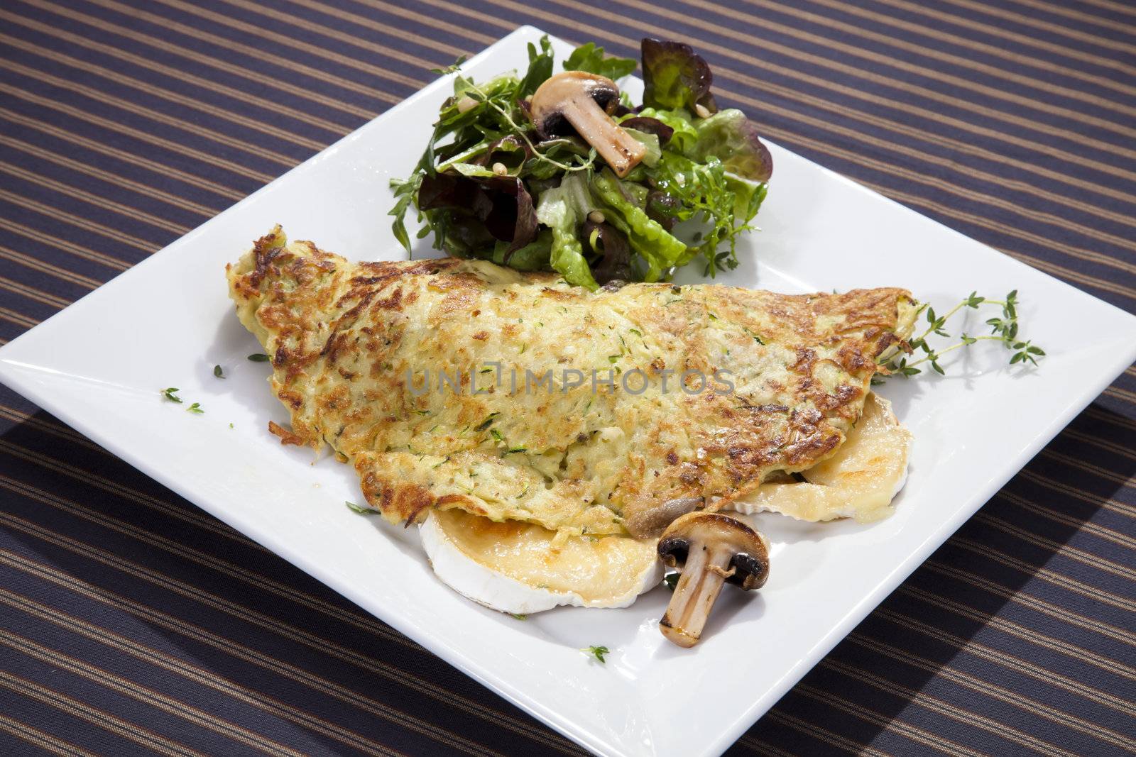 Potato pancake filled by grilled camembert and mushrooms