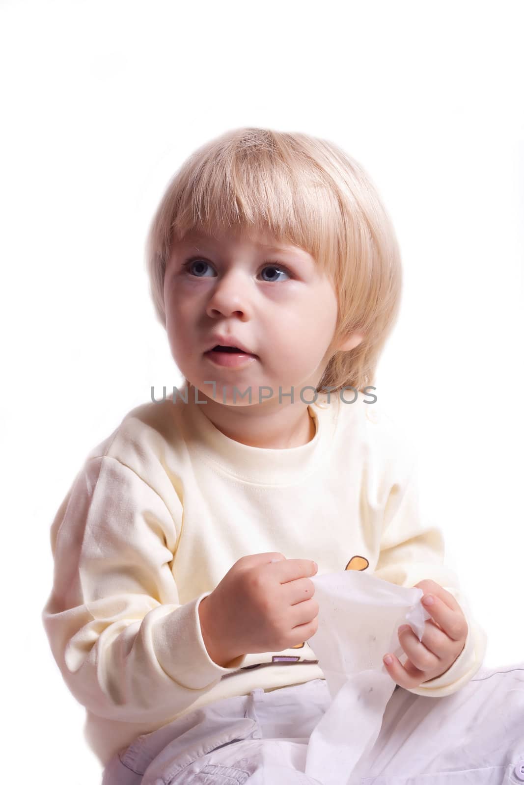 Little girl sits on a white background