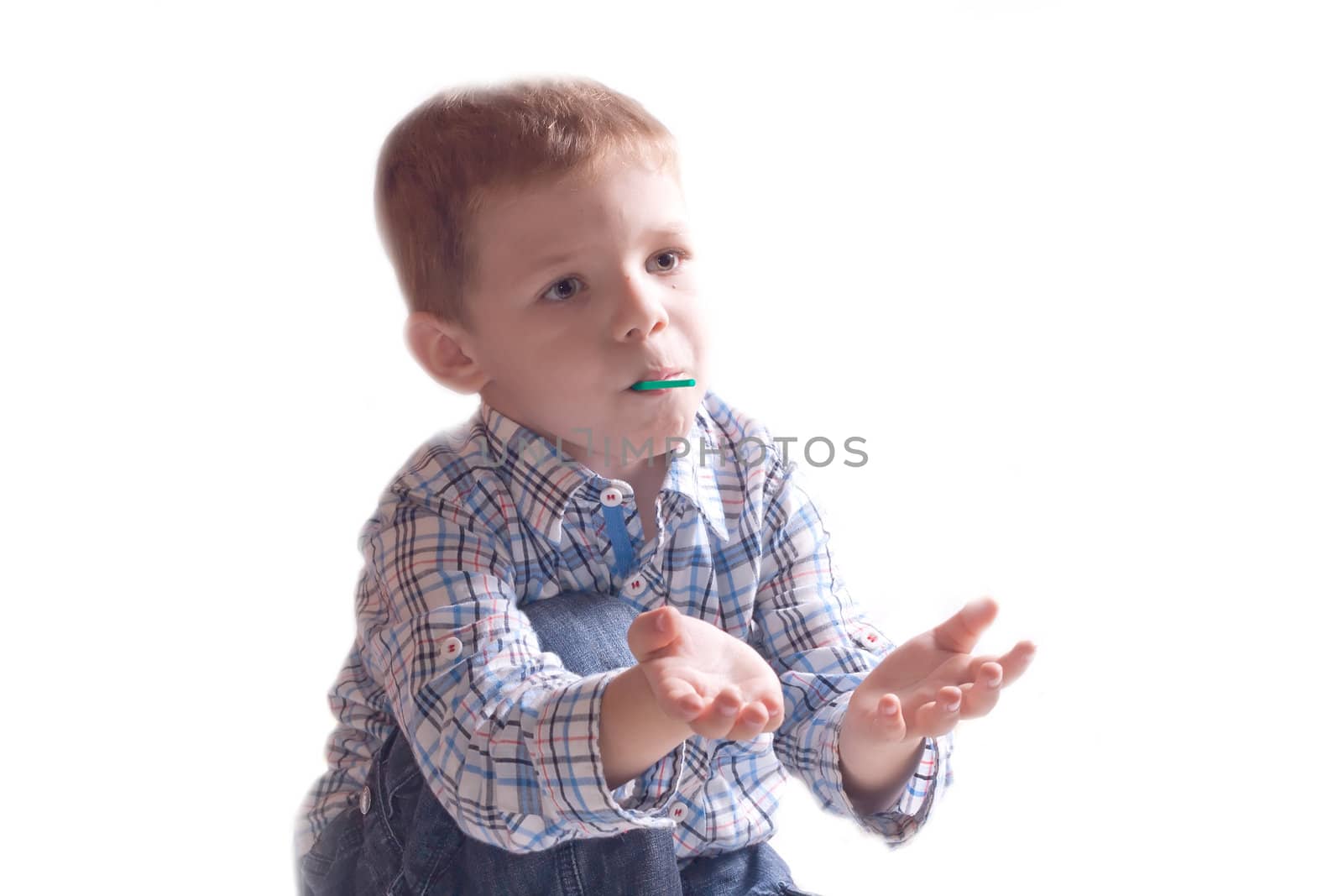 The little boy in a dress with arm outstretched on a white background