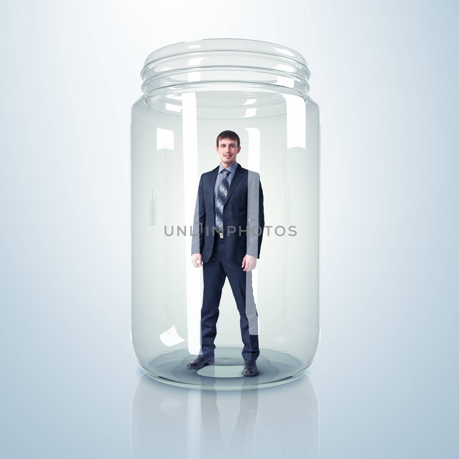 Businessman trapped inside a transparent glass jar