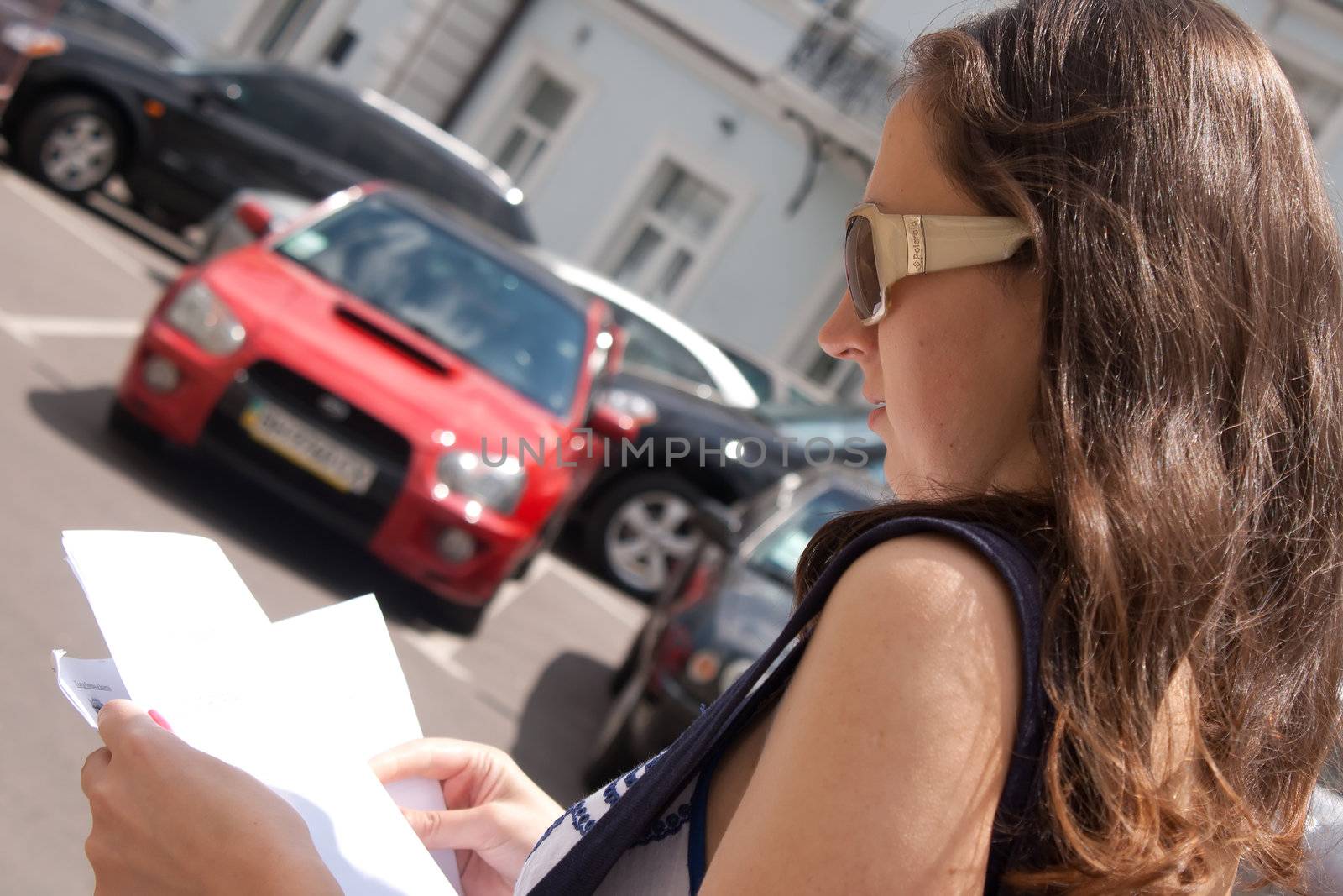 girl tourist with a map of walks around the city Shooting outdoors