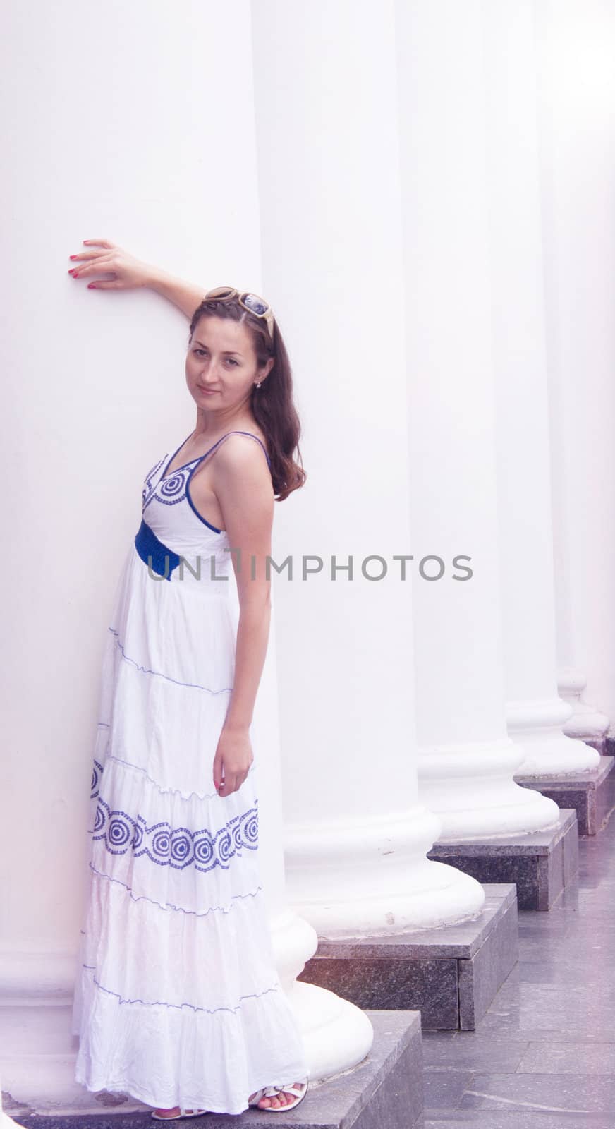 Beautiful girl in a long white columns near the Sarafan photography
