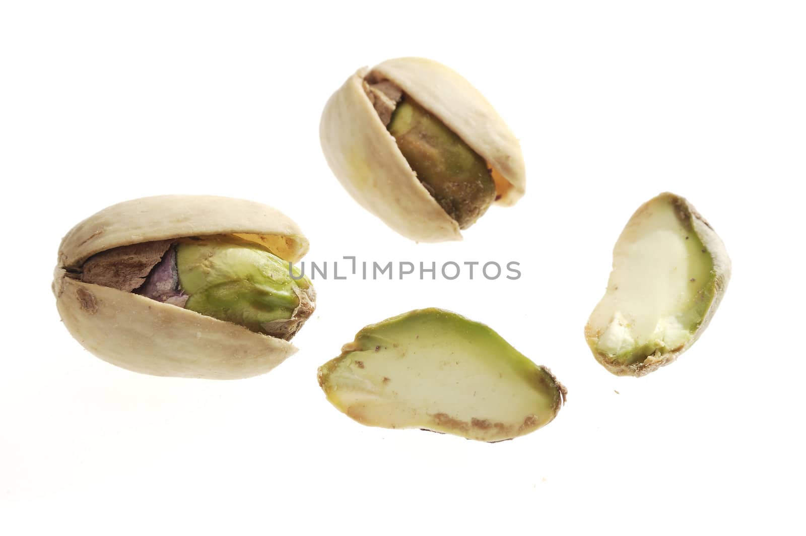 The pistachio nuts closeup on white
