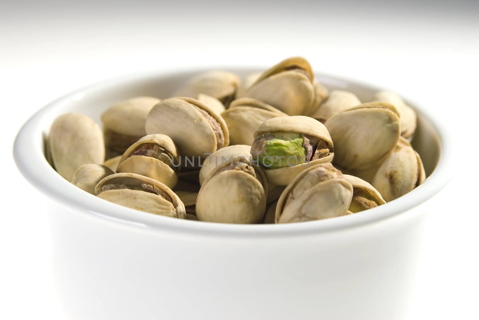 The pistachio nut closeup in porcelain basin