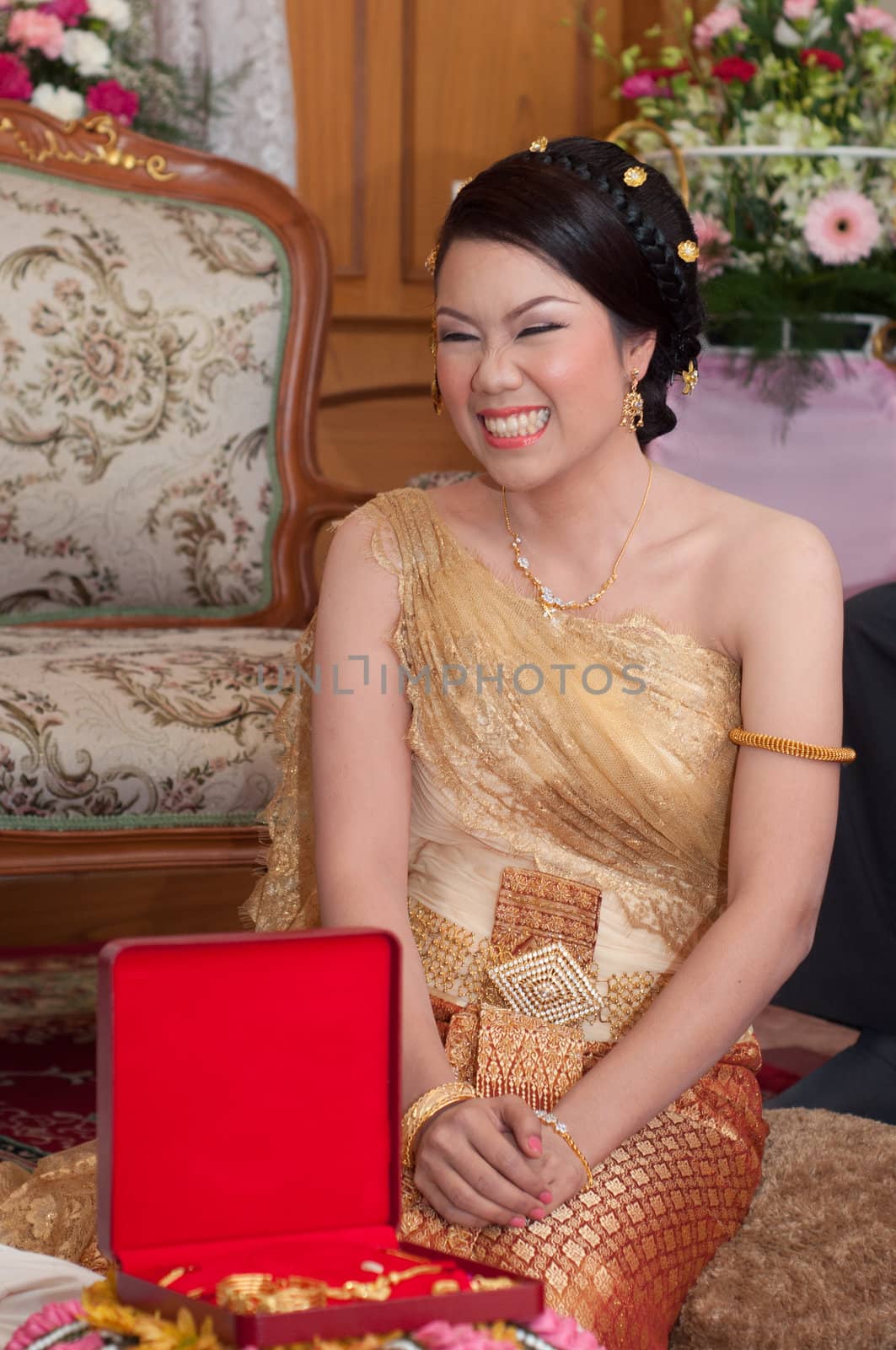 asian thai bride in thai wedding suit smiling in wedding ceremony