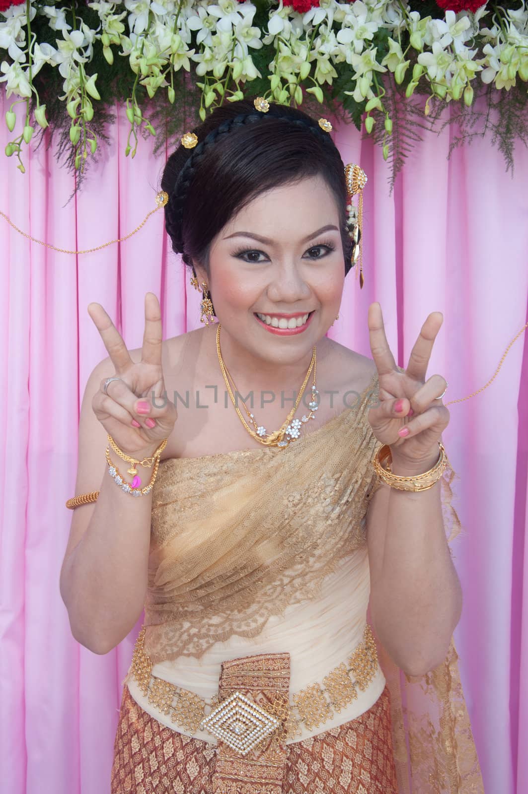asian thai bride in thai wedding suit smiling in wedding ceremony