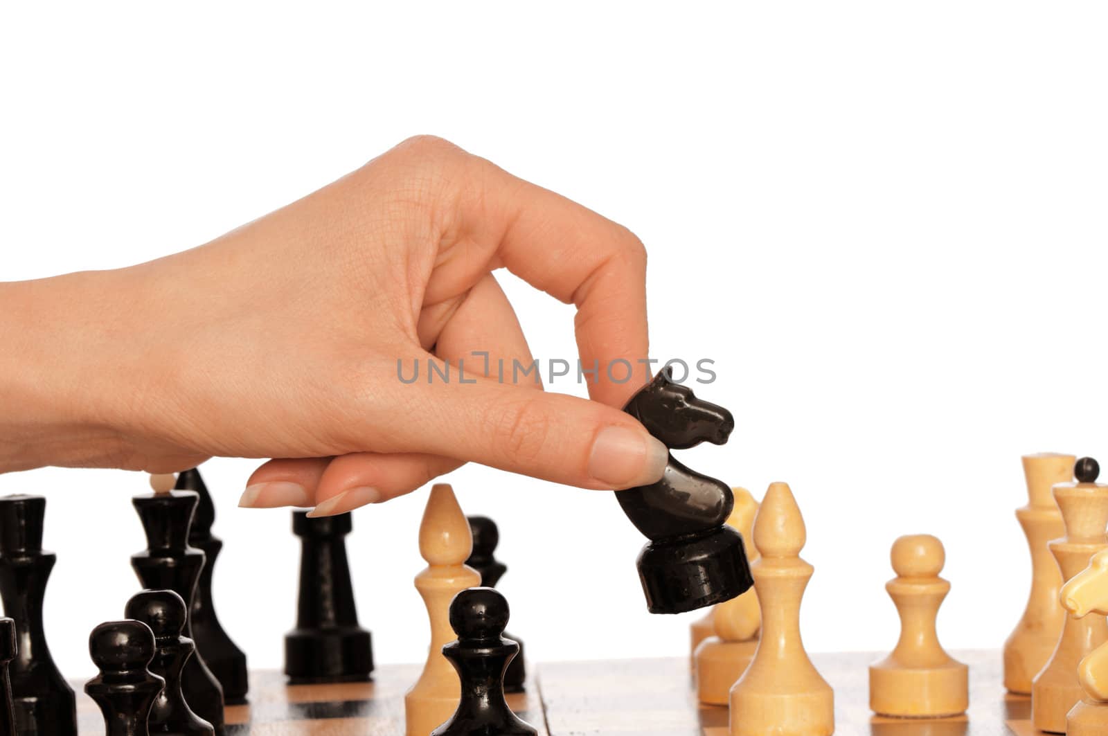 Woman playing chess and making black knight's move