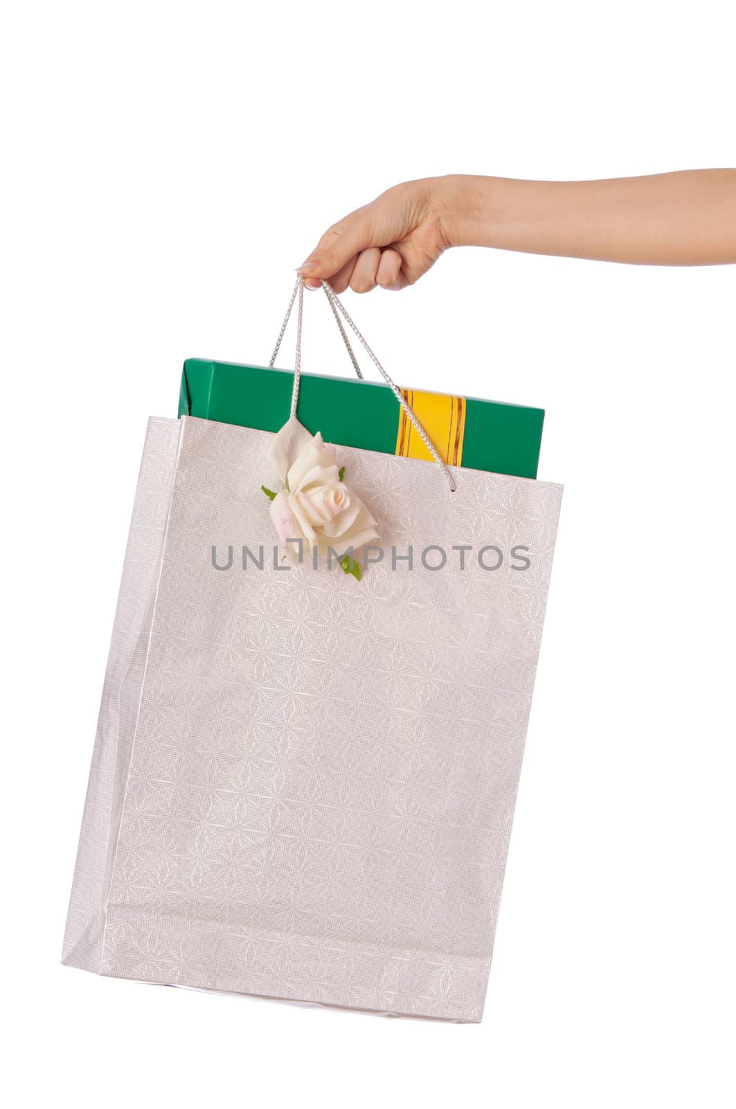 Paper bag with a green box and with a yellow ribbon from the supermarket