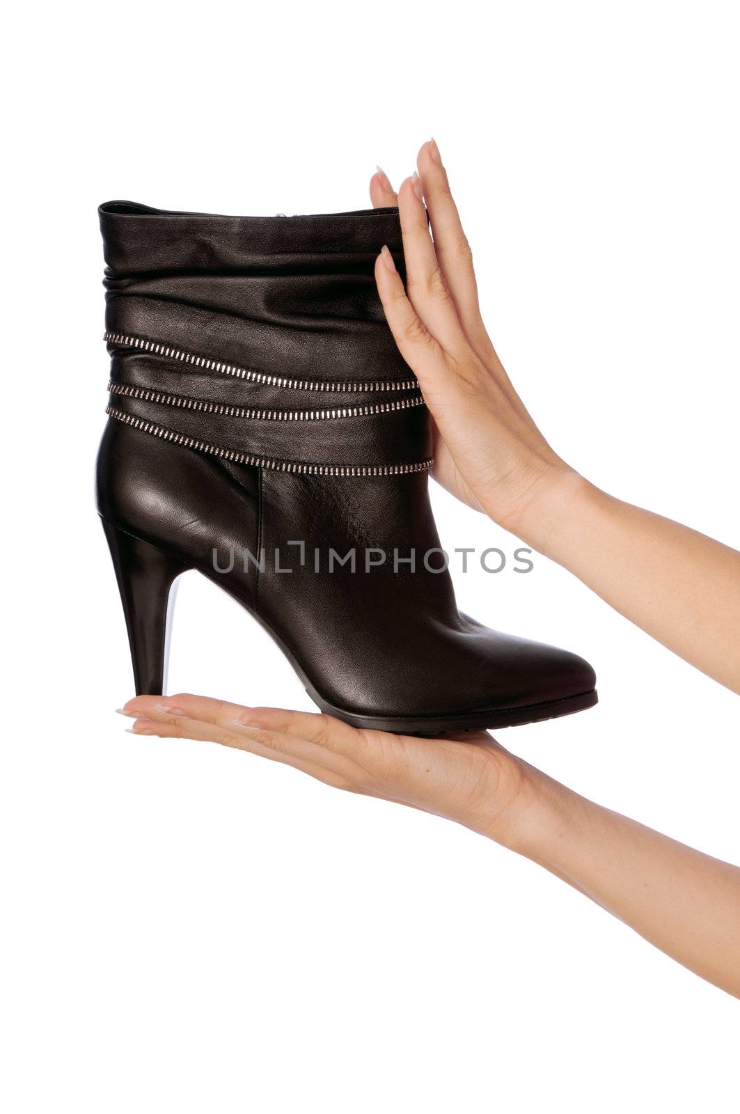 Black female boots in hands at the saleswoman