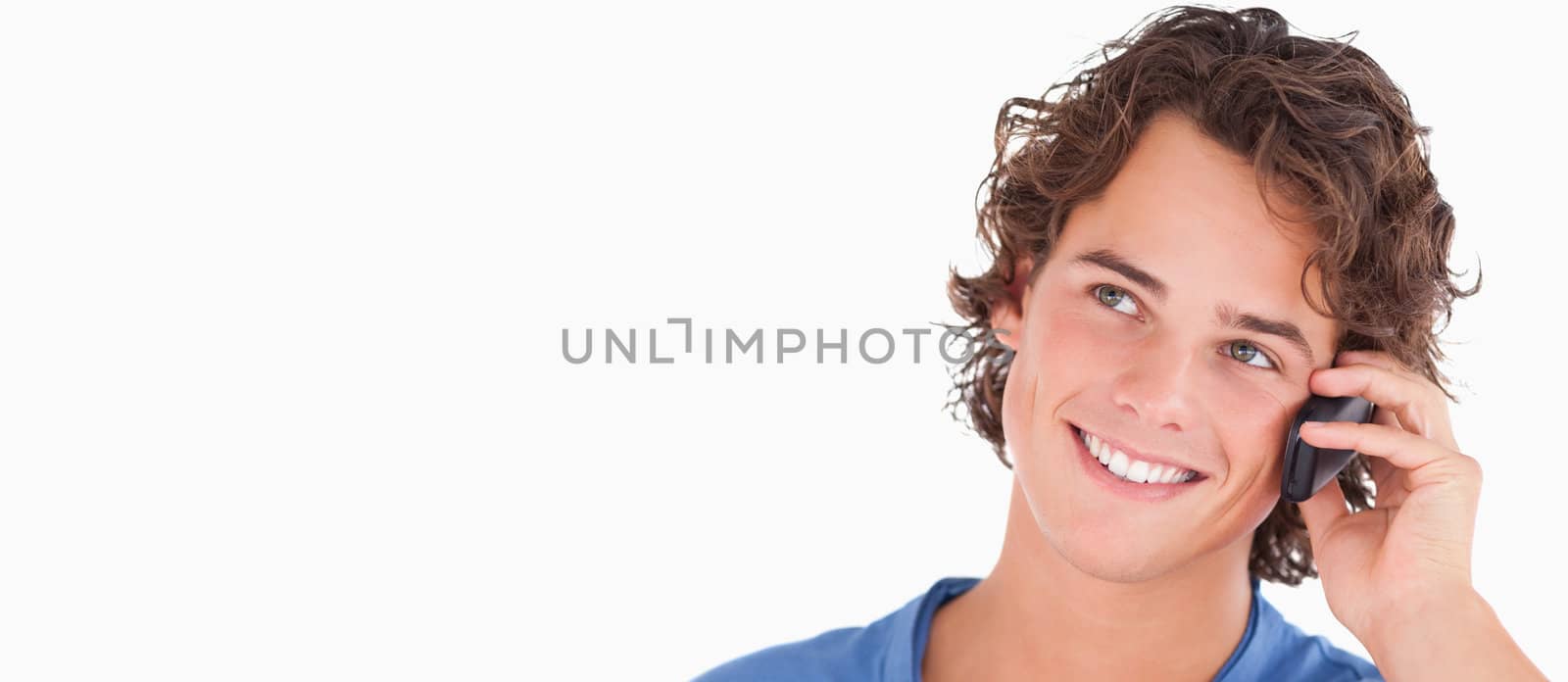 Cute dark-haired guy on th phone in a studio