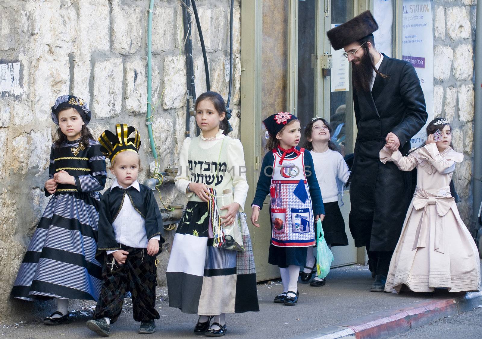 JERUSALEM - MARS 09 : Ultra Orthodox family during Purim in Mea Shearim Jerusalem on Mars 09 2012 , Purim is a Jewish holiday celebrates the salvation of the jews from jenocide in ancient Persia

