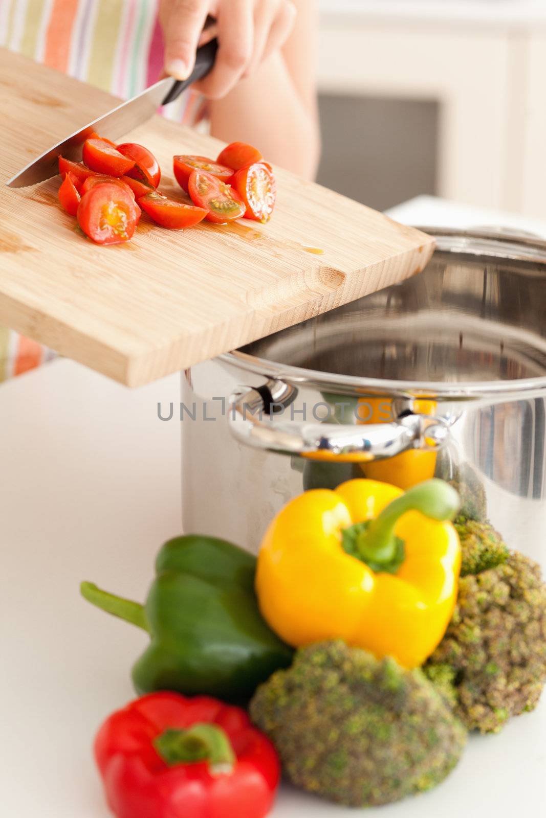 Vegetables are pushed into a cooking pot with a knife