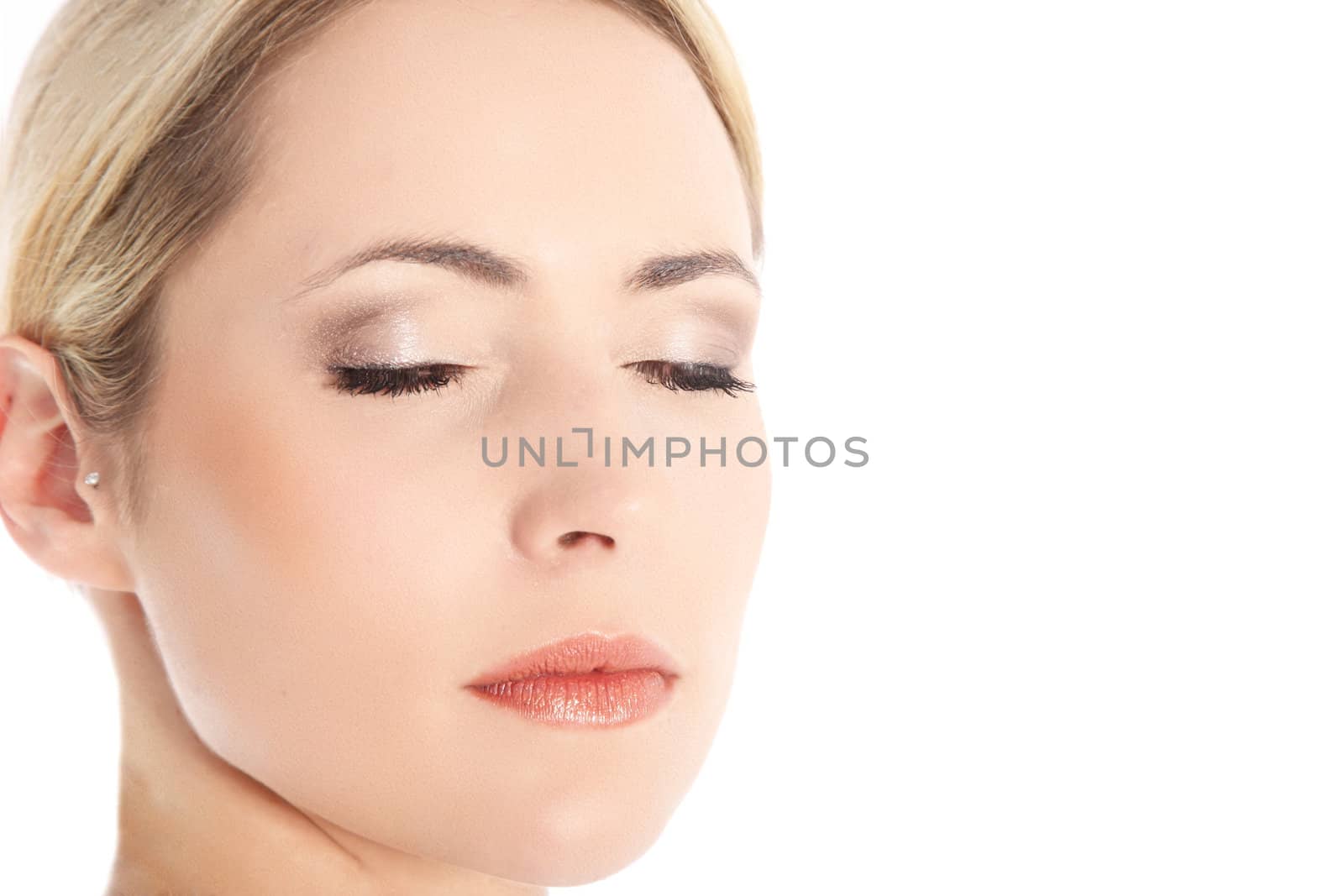 Close-up portrait of woman with eyes closed on white background with copy space
