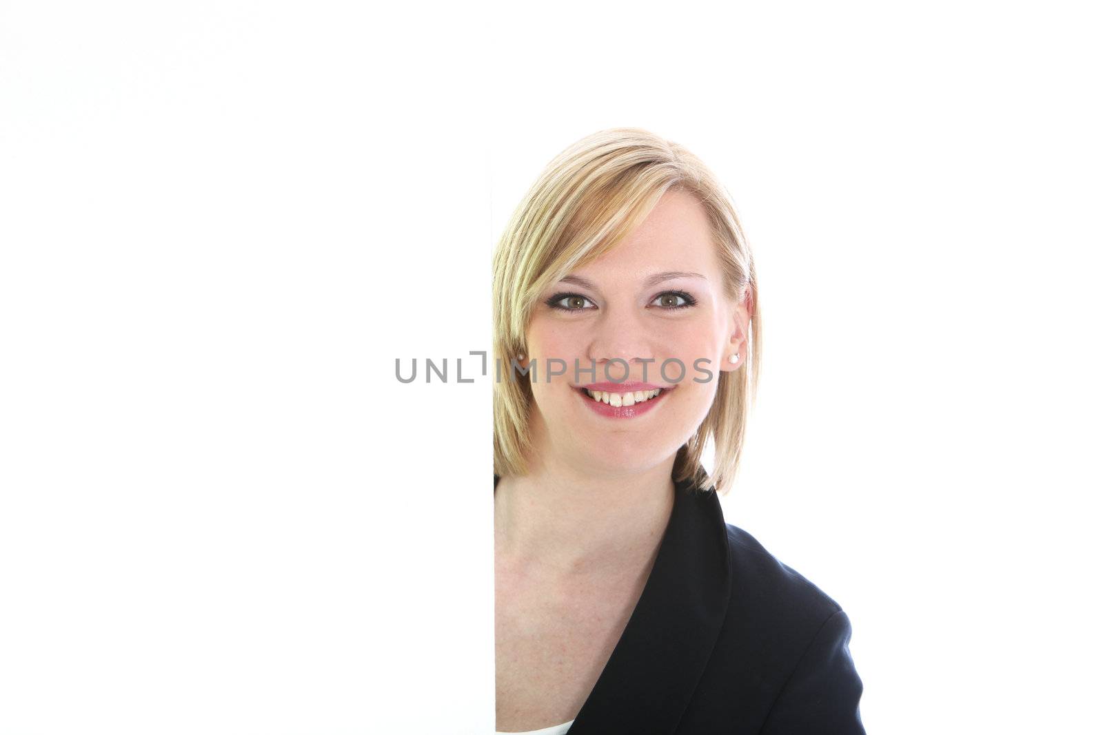 Smiling woman alongside a blank white sign with copyspace for your marketing or text