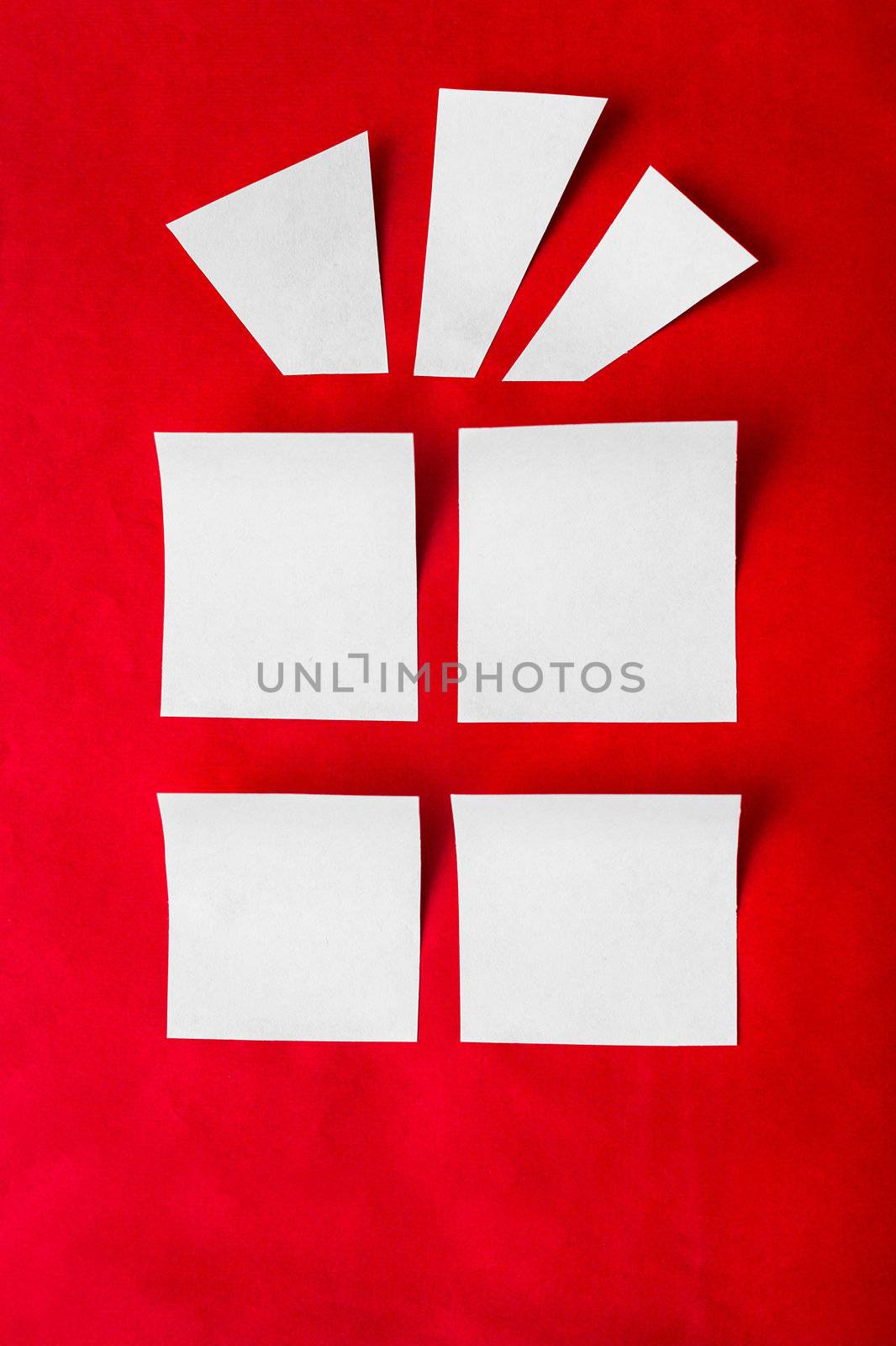 outline a Christmas gift of a white paper on a red background