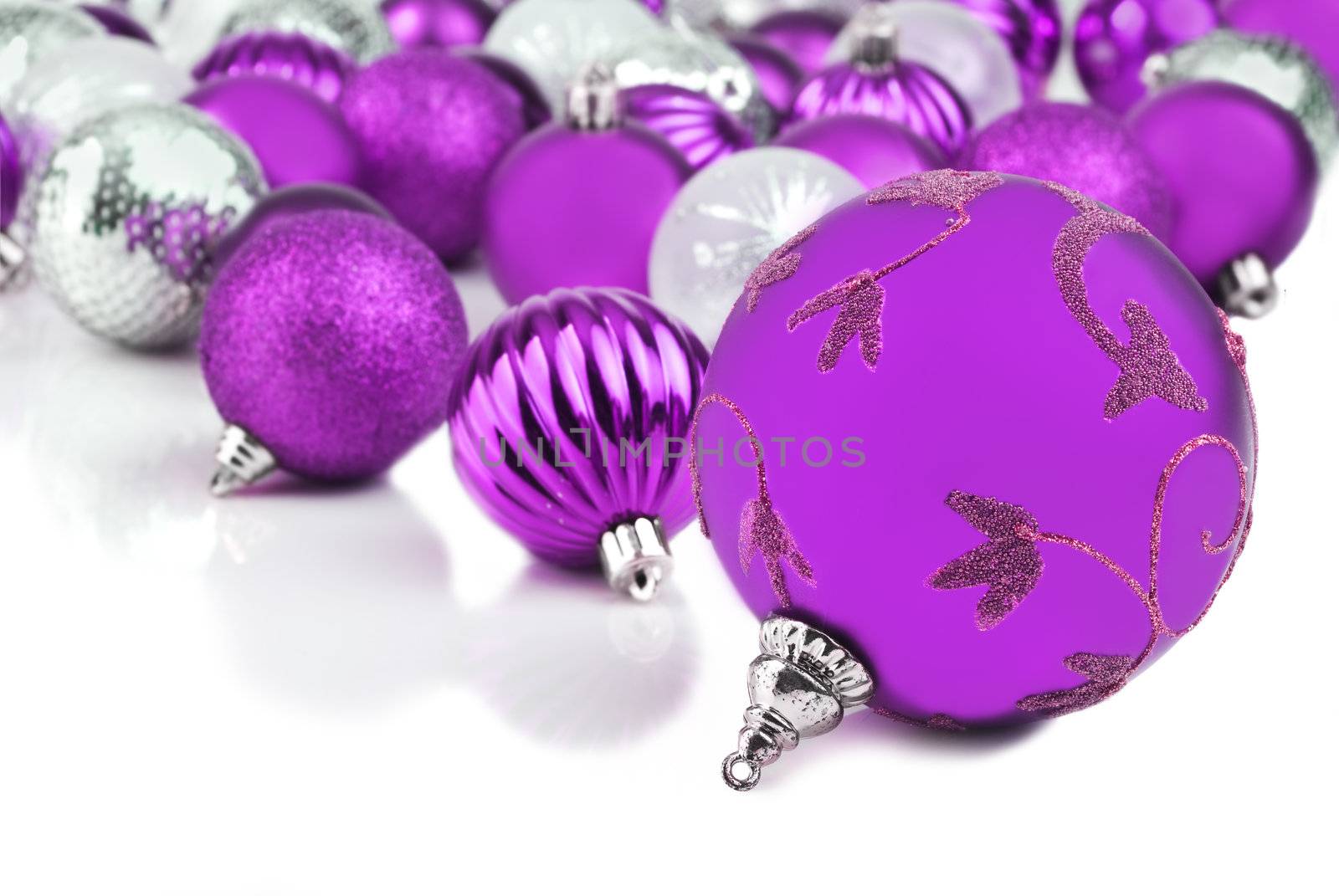 Purple christmas ornament baubles on white by tish1