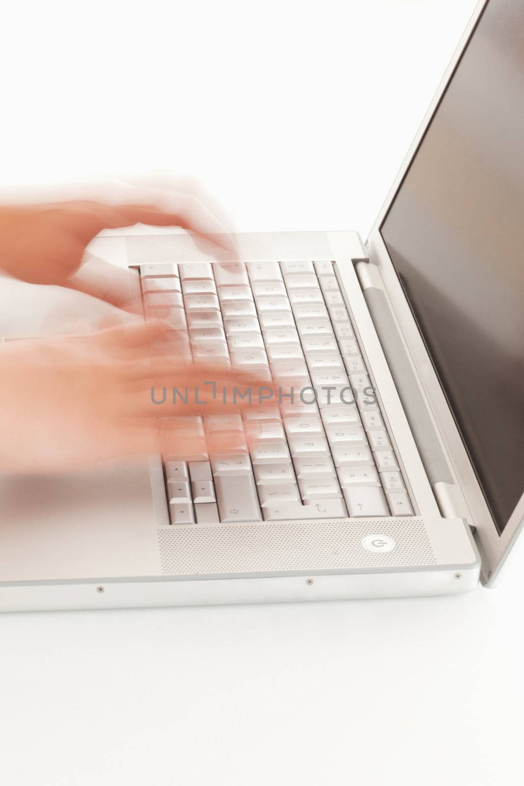 Blurred hands on keyboard of a notebook