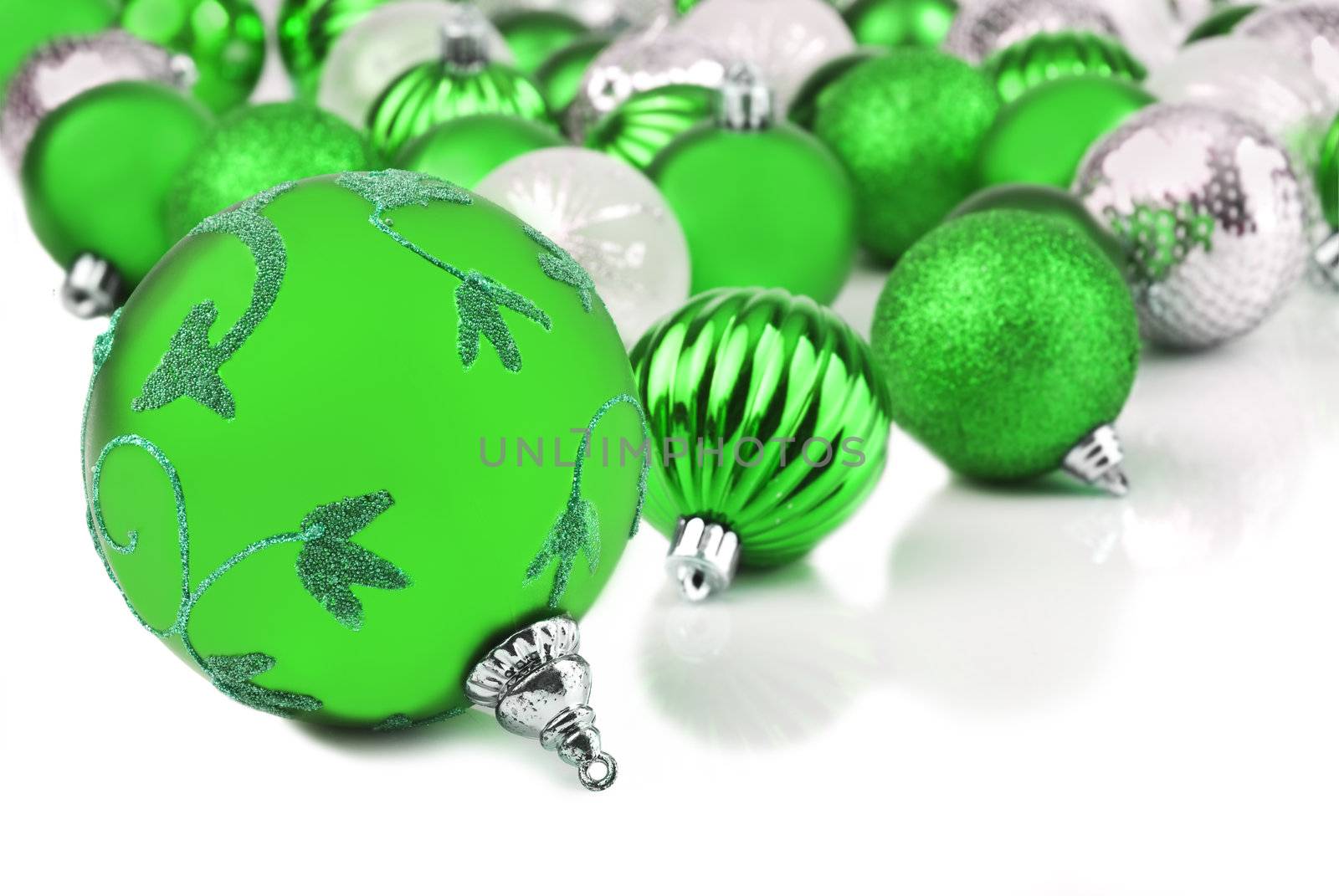 Green christmas ornament baubles on white by tish1