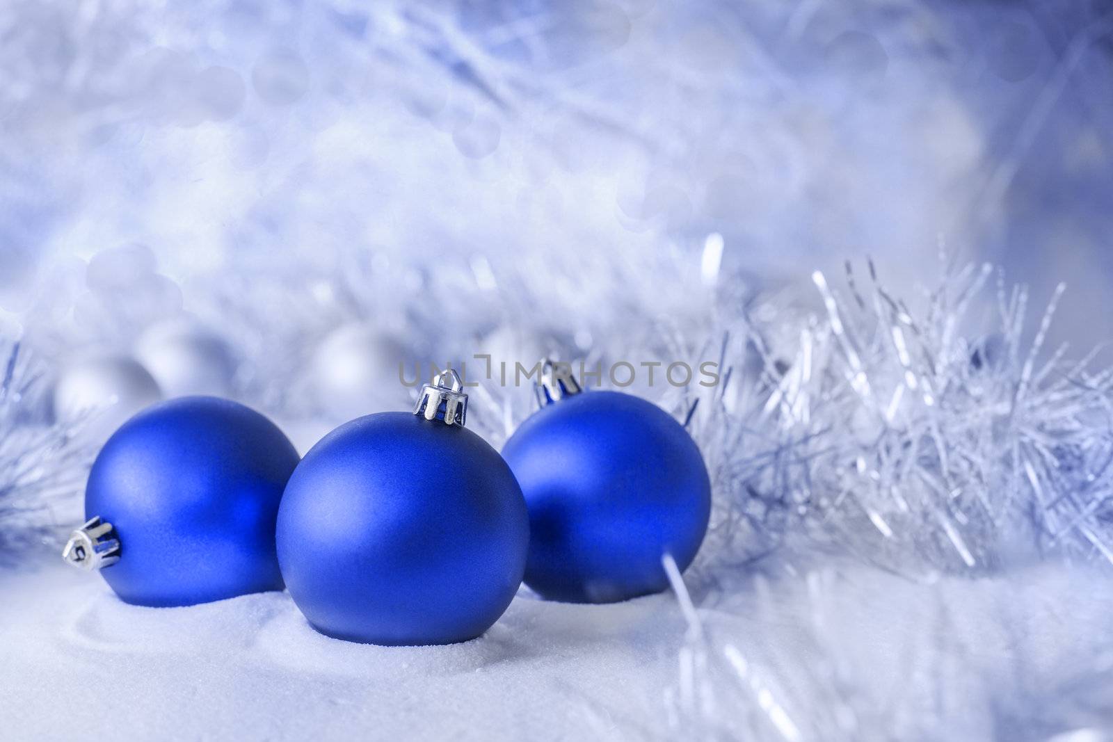 three blue ball lying in the snow