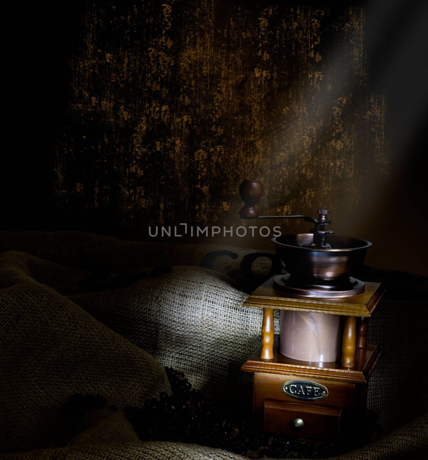 Coffee Mill with beans and burlap, emphasis rays of light