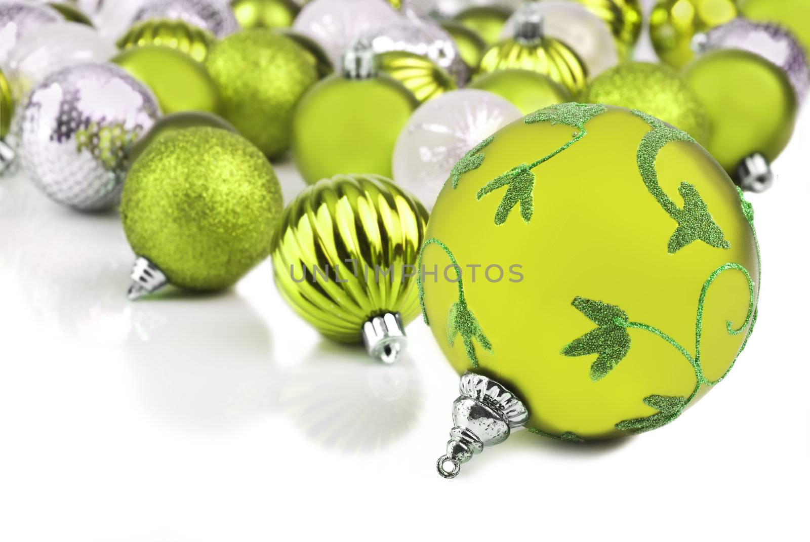 Green christmas ornament baubles on white background
