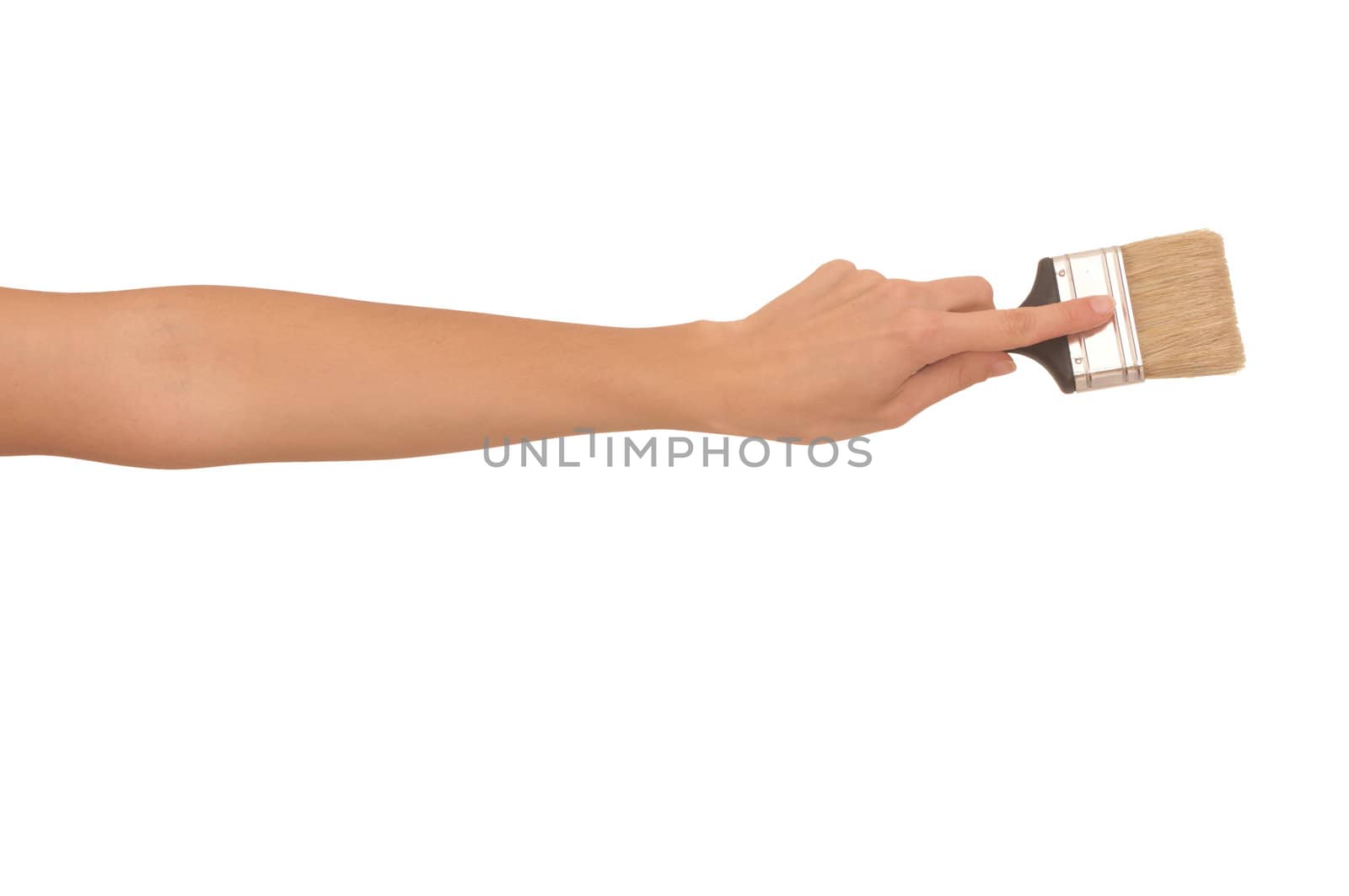 The woman draws the brush on the wall