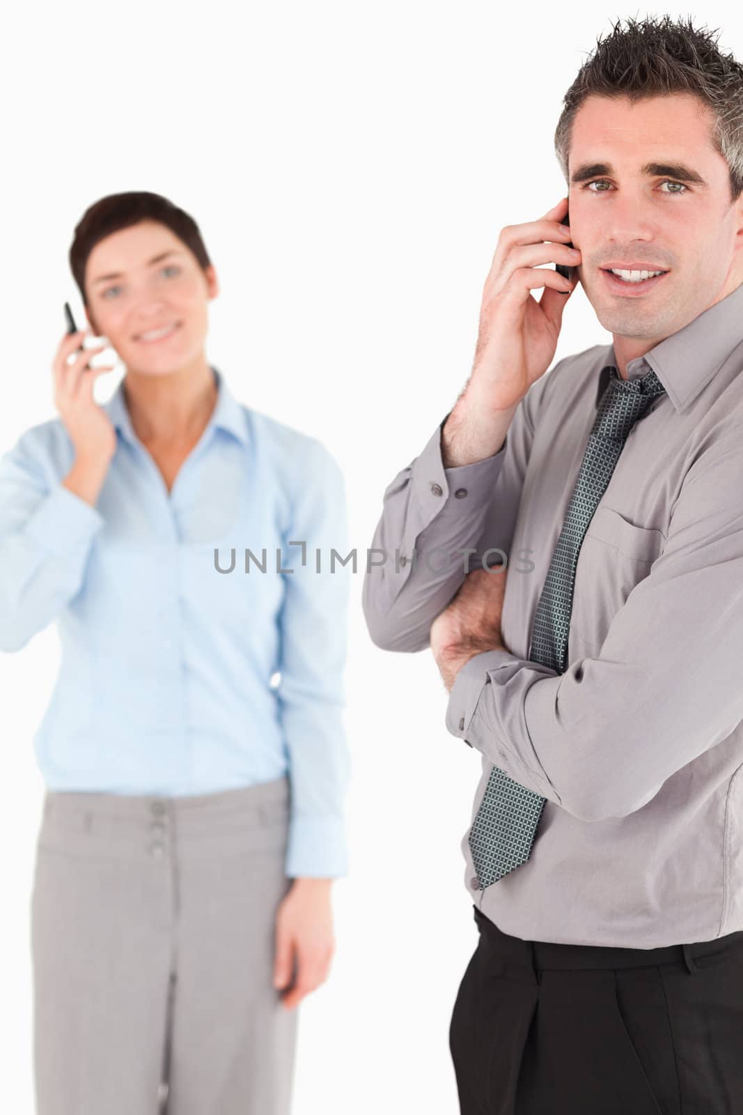 Portrait of a business people making a phone call against a white background