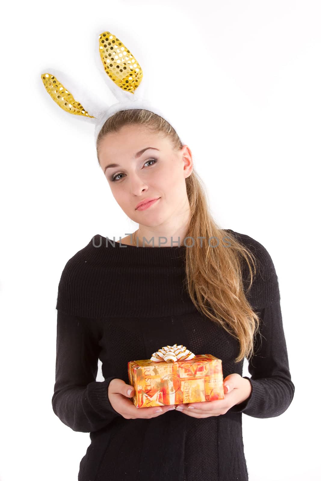 Portrait of a beautiful blonde girl with long hair with a gift in their hands