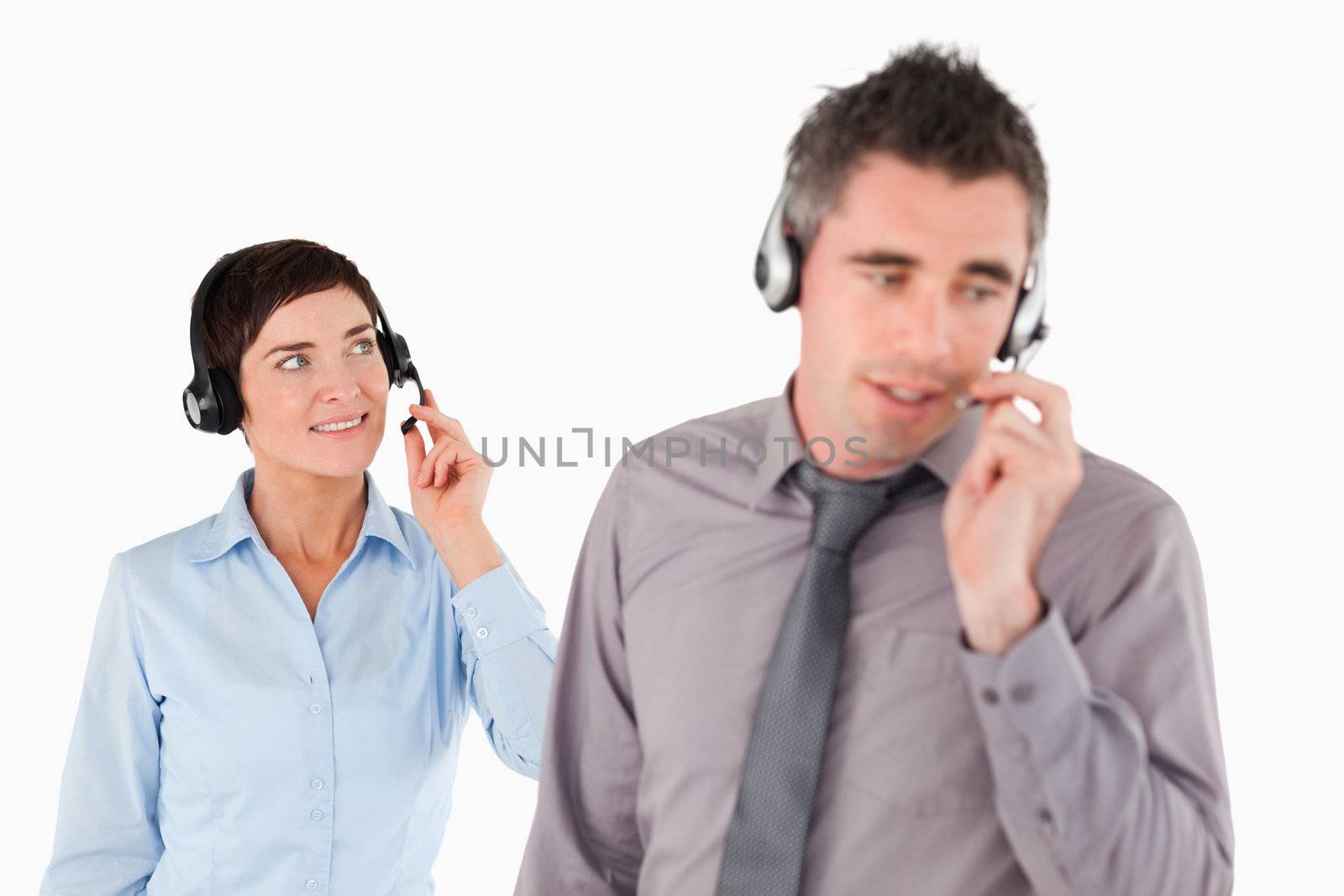 Business people using headsets against a white background